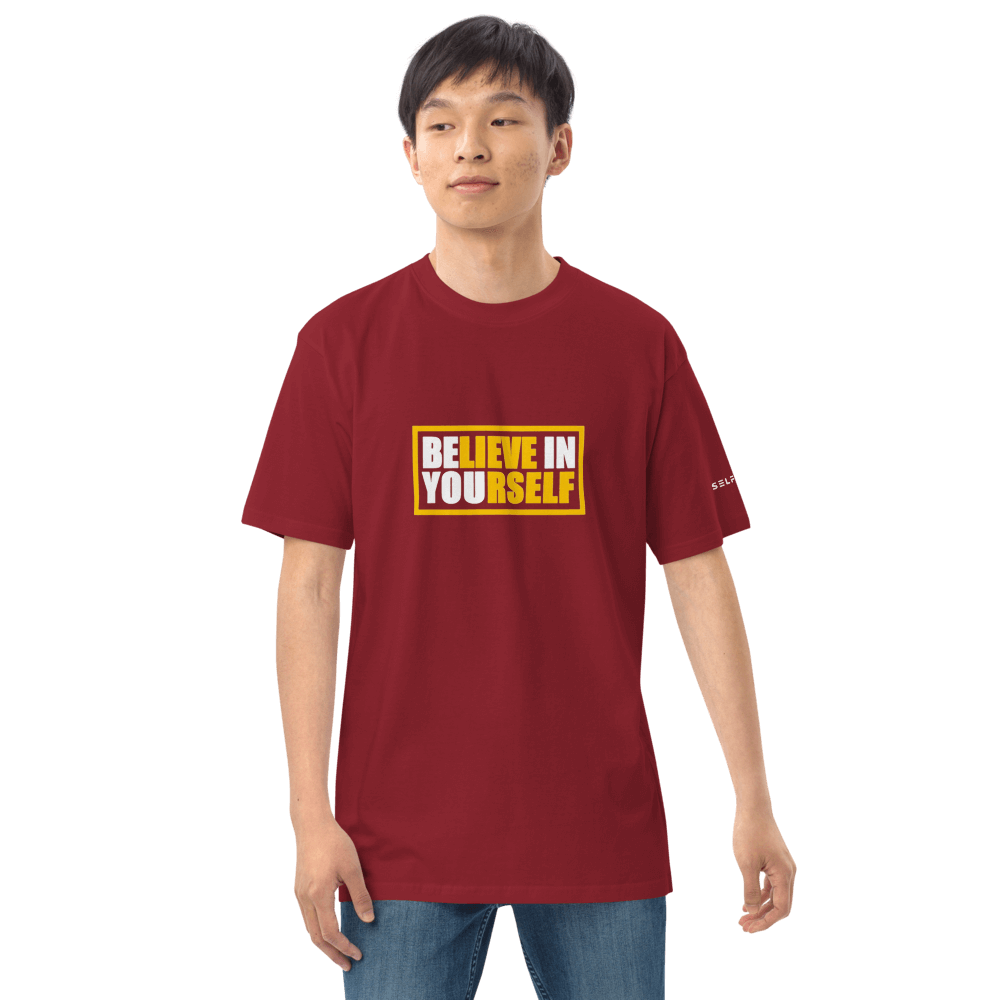 Man wearing a maroon graphic tee that says 'Believe in Yourself', made from premium organic cotton.