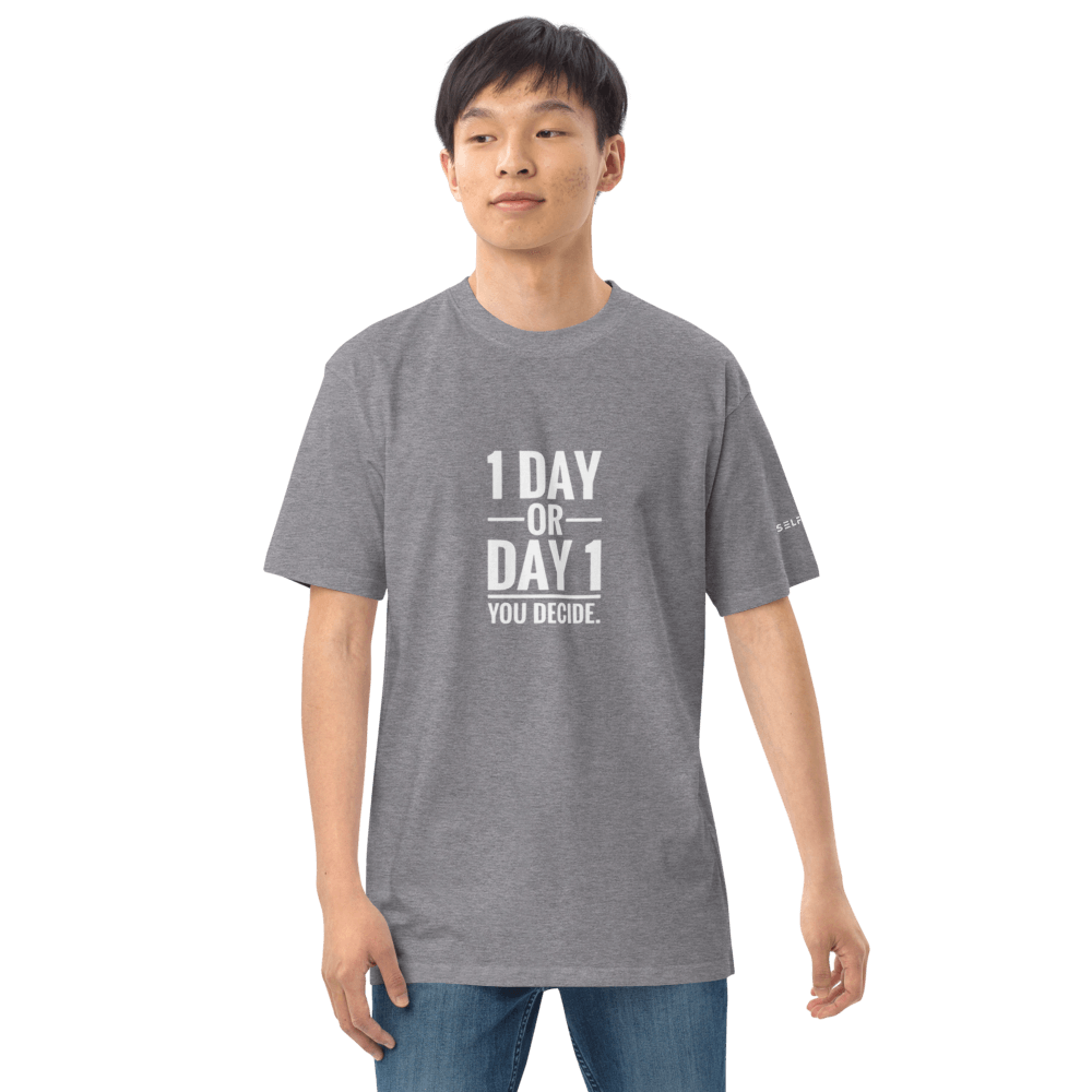 Model wearing a grey t-shirt with the text '1 DAY OR DAY 1 YOU DECIDE', showcasing a casual style.