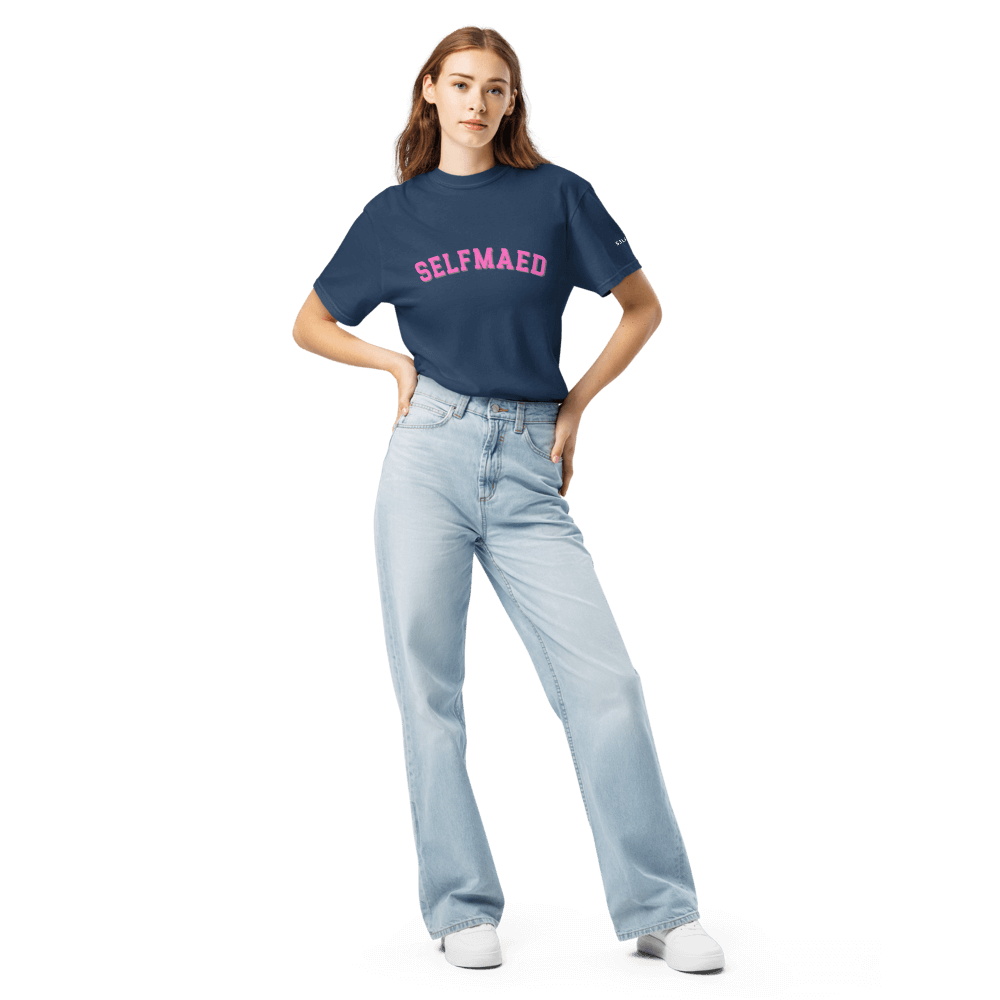 Model wearing a navy selfmaed tee made of organic cotton, styled with light denim jeans for a trendy look.