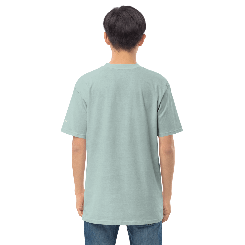 Back view of a male model wearing an essential graphic tee in light blue, showcasing its comfortable fit and organic cotton fabric.