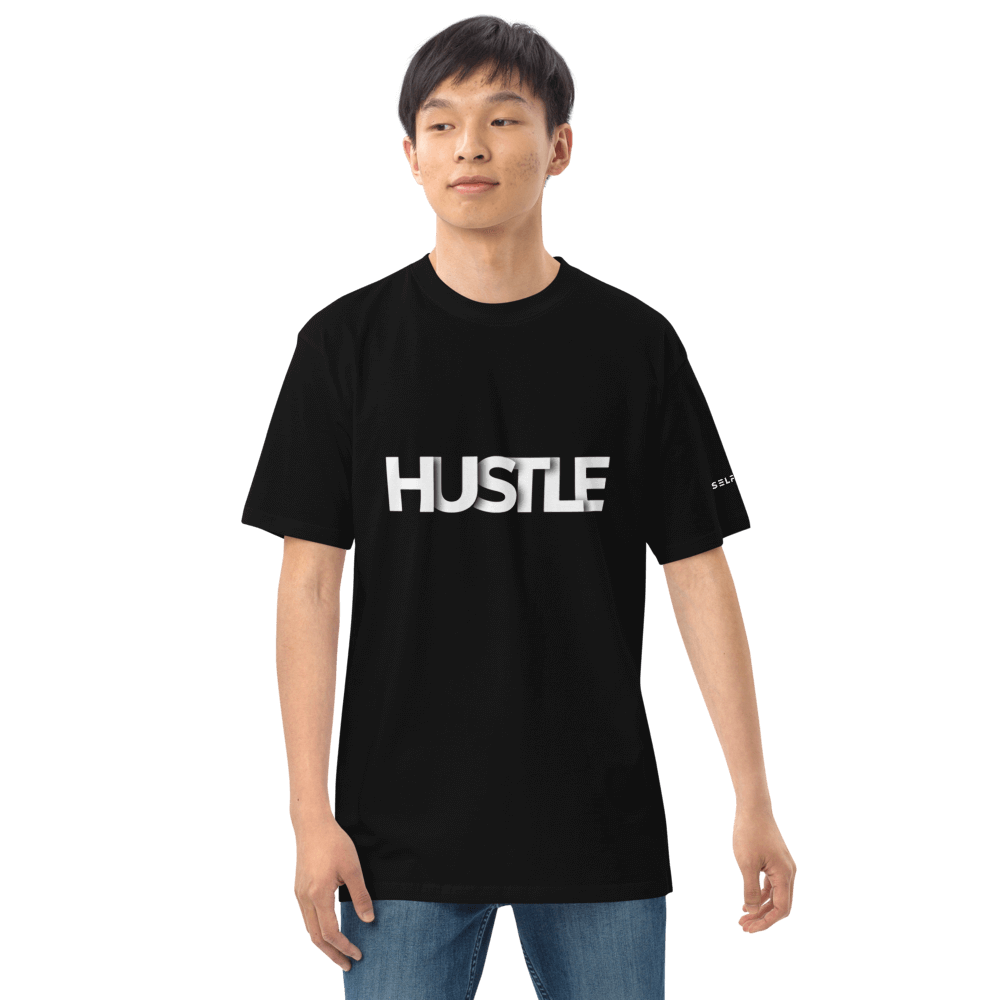 Model wearing the Essential Hustle Tee, a black shirt with bold 'HUSTLE' print, showcasing a stylish and comfortable look.