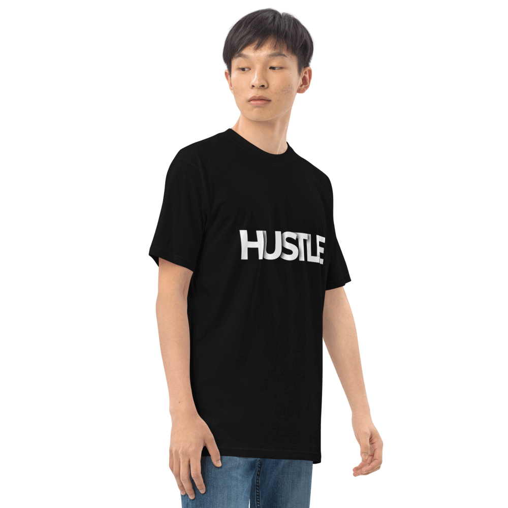 Model wearing black Essential Hustle Tee featuring bold 'HUSTLE' print, showcasing stylish and comfortable design.