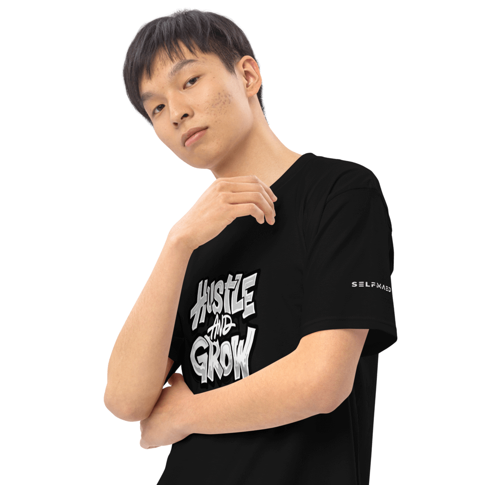 Model wearing Hustler's Tee in black with "Hustle and Grow" graphic, showcasing premium organic cotton apparel.