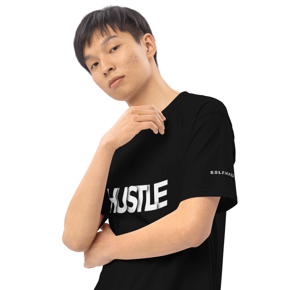 Model wearing Essential Hustle Tee, showcasing stylish black shirt with bold 'HUSTLE' print. Perfect for effortless cool.
