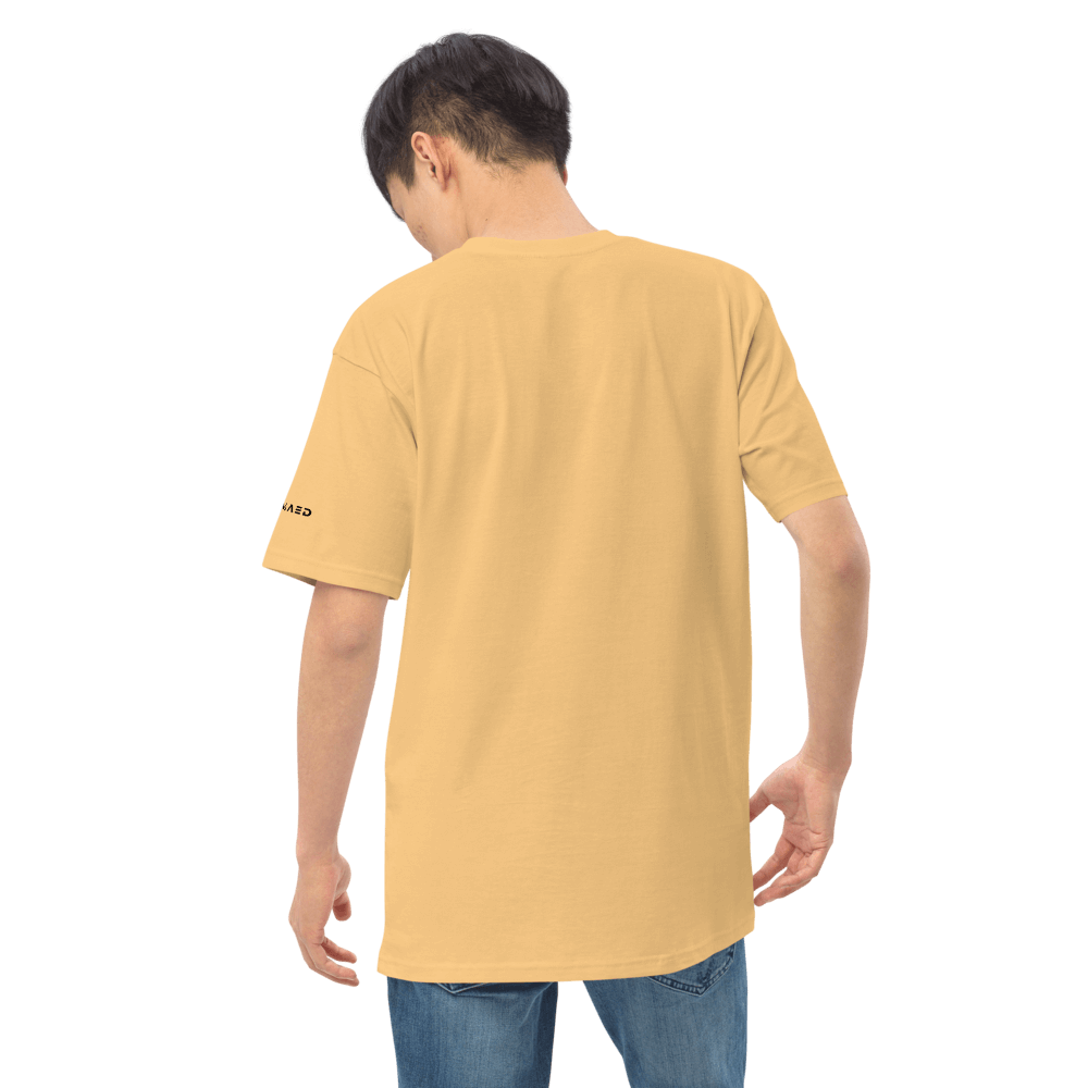 Back view of a model wearing an essential yellow tee made from premium organic cotton.