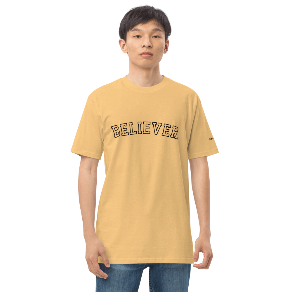 Motivational yellow tee shirt with 'BELIEVER' print, made of soft organic cotton for a casual yet stylish look.