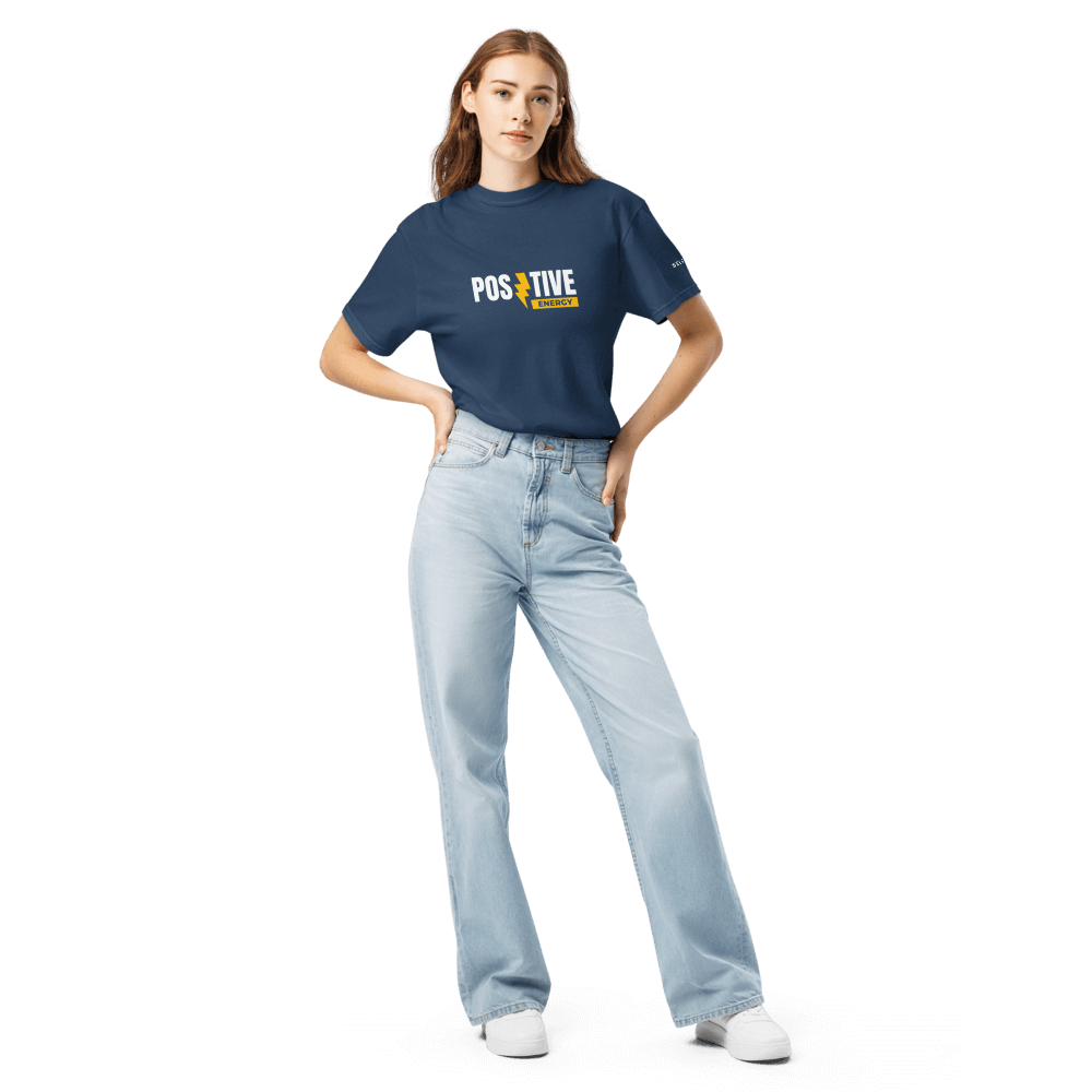 Model wearing Essential Positive Energy Tee in navy, styled with light jeans, showcasing premium organic cotton and unisex fit.